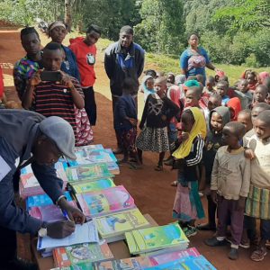 Fr. Andrew supervises the distribution of school items to pupils
